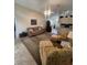 Spacious living room featuring tiled floors, comfortable seating, and a view of the kitchen at 11425 Billingham Blvd, Spring Hill, FL 34609