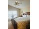 Bright main bedroom with king bed, ceiling fan and window with curtains at 11425 Billingham Blvd, Spring Hill, FL 34609