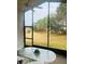 Screened porch with table and chairs, wooded view at 11425 Billingham Blvd, Spring Hill, FL 34609