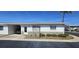 Charming home with a single-car carport, well-maintained landscaping, and a stone facade, set against a bright blue sky at 12400 Park Blvd # 417, Seminole, FL 33772