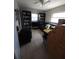 Cozy room with tile floor, full bookcases, couch, and natural light from the windows at 12400 Park Blvd # 417, Seminole, FL 33772