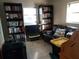 Cozy room with tile floor, full bookcases, couch, and natural light from the windows at 12400 Park Blvd # 417, Seminole, FL 33772