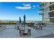 Spacious rooftop terrace with tables, seating, umbrellas and skyline views for dining or relaxation at 145 2Nd S Ave # 523, St Petersburg, FL 33701