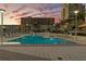Outdoor swimming pool with clear blue water, surrounded by lounge chairs, perfect for evening relaxation at 145 2Nd S Ave # 523, St Petersburg, FL 33701