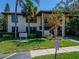 Two-story condo with a red tile roof and tropical landscaping in a sunny community at 1501 Hammock Pine Blvd # 1501, Clearwater, FL 33761