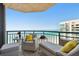 Relax on this tiled balcony with views of the ocean and comfortable outdoor furniture at 1540 Gulf Blvd # 1705, Clearwater, FL 33767