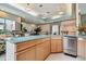 This bar area boasts light wood cabinetry, stainless steel appliances and light blue countertop at 1540 Gulf Blvd # 1705, Clearwater, FL 33767