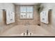 Soaking tub with tile surround, window, and updated fixtures at 1540 Gulf Blvd # 1705, Clearwater, FL 33767
