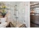 Bathroom featuring a glass shower, updated fixtures, and custom storage at 1540 Gulf Blvd # 1705, Clearwater, FL 33767