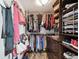 Walk-in closet with custom shelving and racks for optimal organization and storage solutions at 1540 Gulf Blvd # 1705, Clearwater, FL 33767