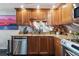 Modern kitchen featuring stainless steel appliances, granite countertops, wood cabinets, and stainless backsplash at 1540 Gulf Blvd # 1705, Clearwater, FL 33767