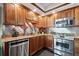 Modern kitchen features stainless steel appliances, granite countertops, and wood cabinets at 1540 Gulf Blvd # 1705, Clearwater, FL 33767
