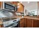 Modern kitchen with stainless steel appliances, granite countertops, and wood cabinets at 1540 Gulf Blvd # 1705, Clearwater, FL 33767