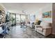 Spacious living room with a fan, balcony, and plenty of natural light at 1540 Gulf Blvd # 1705, Clearwater, FL 33767