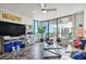 Bright living room features tiled floors, ceiling fan, balcony access, and contemporary furnishings at 1540 Gulf Blvd # 1705, Clearwater, FL 33767