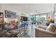 Bright living room features tiled floors, contemporary shelving, and balcony access at 1540 Gulf Blvd # 1705, Clearwater, FL 33767