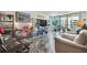 Bright living room features tiled floors, contemporary shelving, and balcony access at 1540 Gulf Blvd # 1705, Clearwater, FL 33767