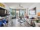 Bright living room features tiled floors, ceiling fan, balcony access, and contemporary furnishings at 1540 Gulf Blvd # 1705, Clearwater, FL 33767