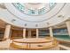 An elegant lobby showcases circular architecture, decorative columns, and scenic beach mural, creating an inviting ambiance at 1540 Gulf Blvd # 1705, Clearwater, FL 33767
