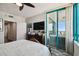 Bright main bedroom with balcony access, tv, and wooden furnishings at 1540 Gulf Blvd # 1705, Clearwater, FL 33767