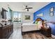 Comfortable main bedroom with large window, ensuite, and wooden furnishings at 1540 Gulf Blvd # 1705, Clearwater, FL 33767