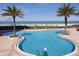 Resort-style pool with tropical landscaping and lounge chairs overlooking the ocean at 1540 Gulf Blvd # 1705, Clearwater, FL 33767