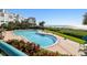 Beautiful outdoor swimming pool with lounge chairs overlooking the white sand beach and blue ocean at 1540 Gulf Blvd # 1705, Clearwater, FL 33767