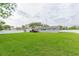 Expansive backyard with lush lawn and a deck at 1613 Druid E Rd, Clearwater, FL 33756