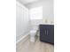 Clean bathroom with navy vanity, shower, and tile floor at 1613 Druid E Rd, Clearwater, FL 33756