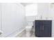 Modern bathroom with a walk-in shower, white subway tile, and dark vanity at 1613 Druid E Rd, Clearwater, FL 33756