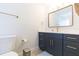 Modern bathroom with navy vanity, white countertop, and gold accents at 1613 Druid E Rd, Clearwater, FL 33756