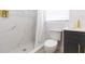 Updated bathroom with marble shower, white toilet, and dark vanity at 1613 Druid E Rd, Clearwater, FL 33756