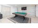 Relaxing game room with pool table, large screen TV, and comfortable seating at 1613 Druid E Rd, Clearwater, FL 33756
