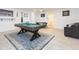 Basement game room with pool table, seating area, and game tables at 1613 Druid E Rd, Clearwater, FL 33756