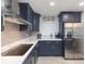 Renovated kitchen, featuring blue cabinetry and stainless steel appliances at 1613 Druid E Rd, Clearwater, FL 33756