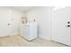 Bright laundry room with washer, dryer, and exterior access at 1613 Druid E Rd, Clearwater, FL 33756