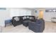 Comfortable living room featuring a sectional sofa and an ottoman at 1613 Druid E Rd, Clearwater, FL 33756