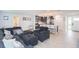 Open living area with dark gray sectional sofa and kitchen island view at 1613 Druid E Rd, Clearwater, FL 33756