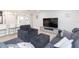 Living room with sectional sofa, large TV, and ample natural light at 1613 Druid E Rd, Clearwater, FL 33756