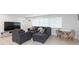 Living room with sectional sofa, small table, and four chairs at 1613 Druid E Rd, Clearwater, FL 33756