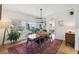 Bright dining room featuring a large table, modern light fixture, and stylish decor at 1640 Sea Breeze Dr, Tarpon Springs, FL 34689