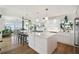 Modern white kitchen with a large island, pendant lighting, and stainless steel appliances at 1640 Sea Breeze Dr, Tarpon Springs, FL 34689