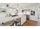 Modern kitchen island with white countertop, cooktop, and bar stool seating at 1640 Sea Breeze Dr, Tarpon Springs, FL 34689