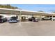 View of the covered carport parking area with multiple vehicles parked in designated spaces at 1655 S Highland Ave # D238, Clearwater, FL 33756