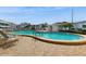 Relaxing kidney-shaped pool with lounge chairs at 1655 S Highland Ave # D238, Clearwater, FL 33756