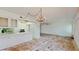 Open dining area with kitchen access and chandelier at 1655 S Highland Ave # D238, Clearwater, FL 33756