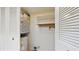 Laundry closet with water heater and shelving at 1655 S Highland Ave # D238, Clearwater, FL 33756