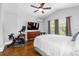 Bedroom features an exercise bike, television, wood floors, and an air conditioning unit at 205 W North St, Tampa, FL 33604