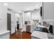 Modern kitchen with stainless steel appliances, white cabinetry, marble countertops, and hardwood floors at 205 W North St, Tampa, FL 33604