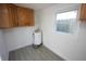 This utility room features a water heater, a window and overhead cabinets at 205 Washington Ave, Oldsmar, FL 34677